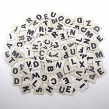 Letter tiles being rearranged to form a new word