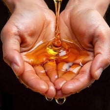 Hands applying oil during an anointing ceremony