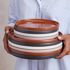 A stack of ceramic plates and other crockery