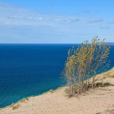 A calm sea under a clear, peaceful sky