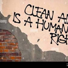 A polluted industrial scene alongside graffiti containing vulgar imagery