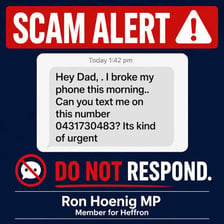 A phone displaying a warning about a possible scam