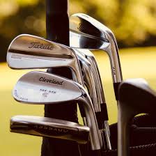 A golf iron and a household clothes iron shown together.