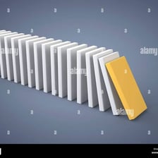 A line of falling dominoes illustrating a chain reaction