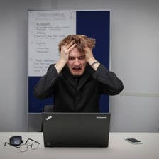 A person crossing out an incorrect written answer.