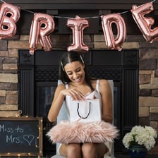 A group celebrating with a bride-to-be before her wedding.