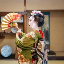 A geisha wearing traditional Japanese dress and makeup
