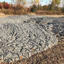 Thick mud slowly flowing from the ground