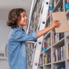 A hand returning a book to a shelf