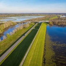 A raised artificial embankment beside a river