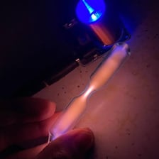 A discharge lamp glowing with the light associated with krypton gas.