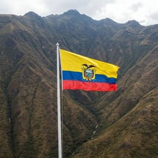 An Ecuadorian landscape with the Andes and an Ecuador flag