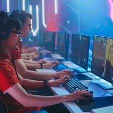 A person competing in a video game at a gaming computer