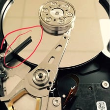 A computer hard drive shown alongside a paved road