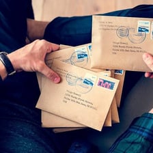A person handing an unstamped letter directly to its recipient