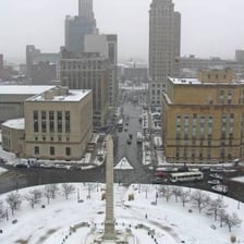 Snow falling in a brief flurry over a town.