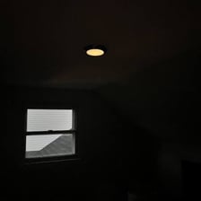 A dark room with a lamp switched off.