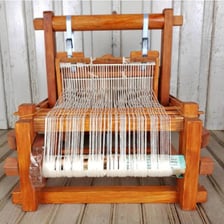 A weaver working at a traditional hand loom