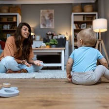 A babysitter caring for a young child indoors