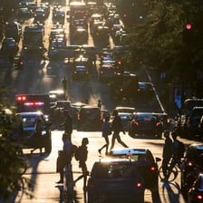 Crowds of commuters travelling through a busy city at rush hour