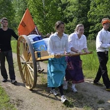 A person leading others along a newly cleared trail