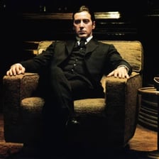 A suited mobster in a classic Mafia-style scene.