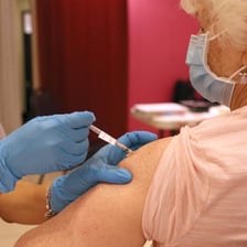 A healthcare worker administering a booster vaccination
