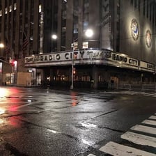 An empty city street at night during a curfew