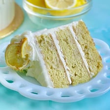Slice of lemon drizzle cake with a glossy lemon topping