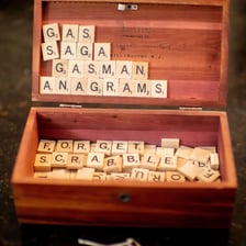 Letter tiles being rearranged to form a new word.