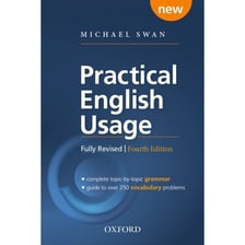 An English-language usage guide open beside written notes