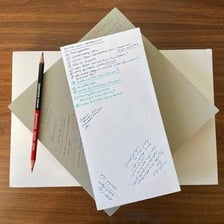 Written information and notes arranged on a desk