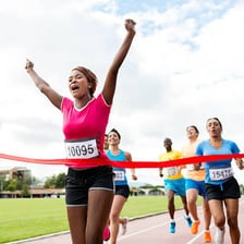 A runner reaching a finish line.
