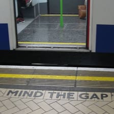 A London Underground platform showing a Mind the Gap warning sign