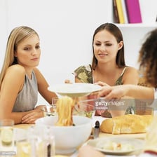 A diner serving themselves a third helping of food