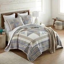 A continental quilt and a patchwork quilt shown as two types of bed covering.