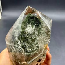 A clear quartz crystal with a hexagonal prism shape