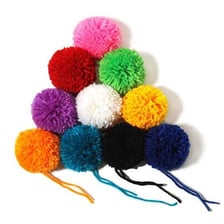 A small fluffy pom-pom made from wool or yarn.