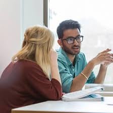 An independent examiner reviewing university examination papers
