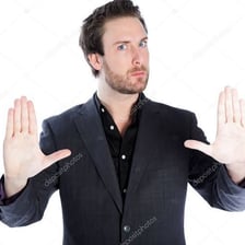 A person raising a hand to signal someone to slow down or calm down