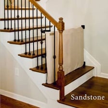 A railing running alongside a flight of stairs.