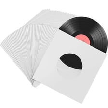 A vinyl LP record beside its album sleeve