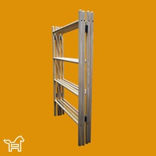 A folding clothes horse holding laundry indoors.