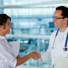 A person giving an evidently halfhearted handshake