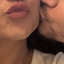 A person giving another person a gentle kiss on the cheek