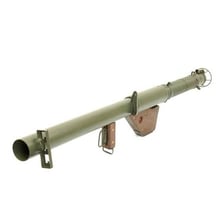 A historical bazooka rocket launcher being held at shoulder height.