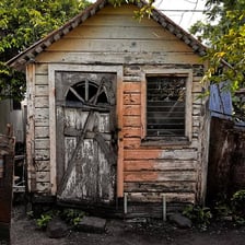 A visibly unstable, poorly built wooden structure