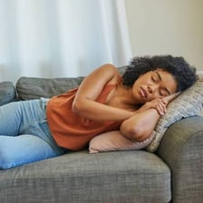 A person sleeping briefly in an armchair