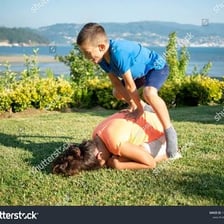 Children jumping over one another in a game of leapfrog