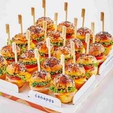Small savoury canapés arranged on a platter.